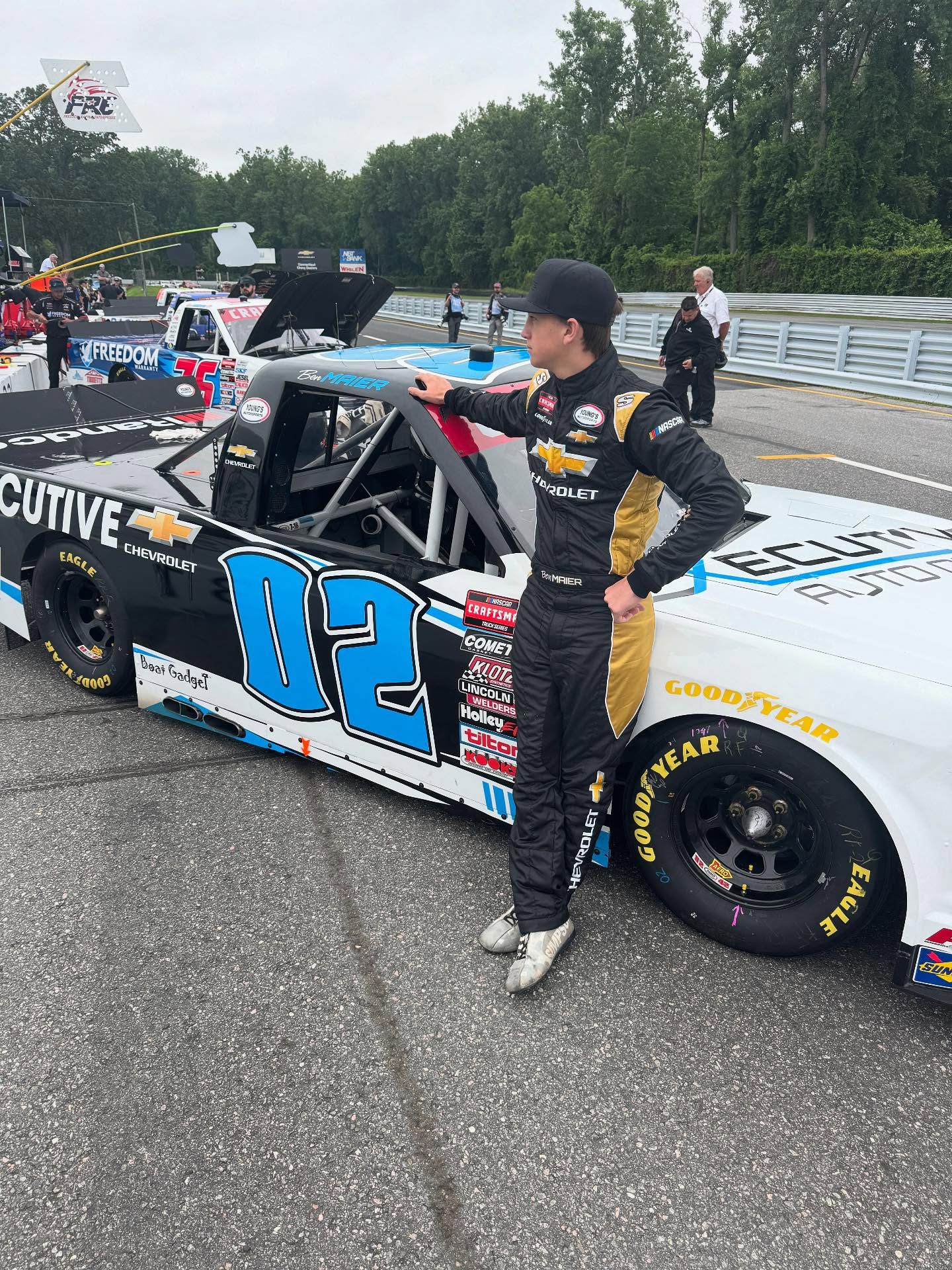 Professional NASCAR driver beside race car - iRacing coaching